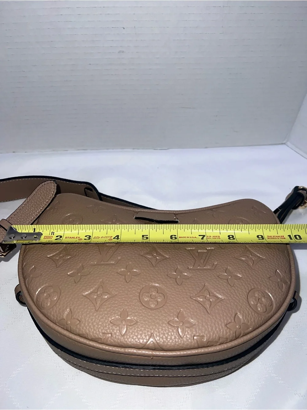 Designer inspired half-moon shoulder bag in a neutral taupe leather w/monogram